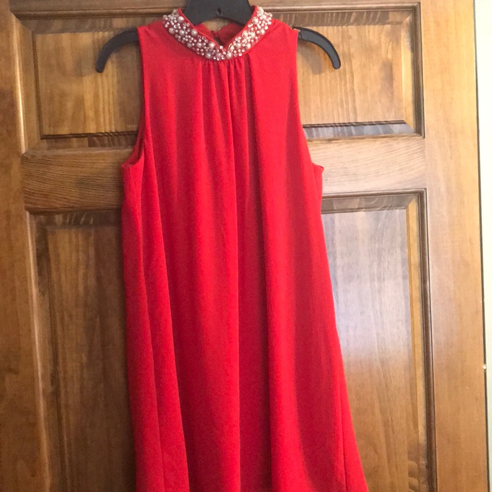 Red party dress with pearl collar and keyhole back